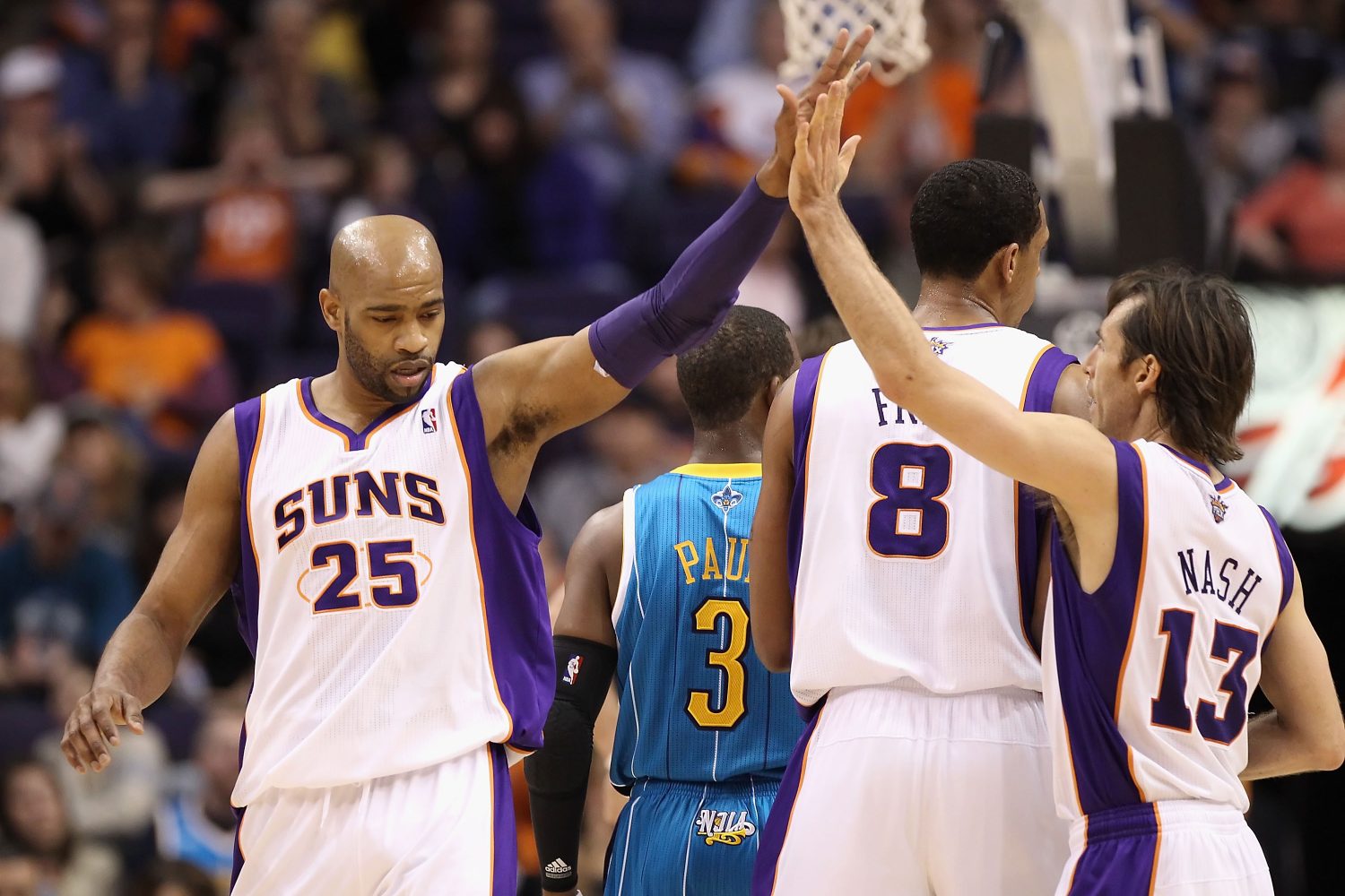 PHOENIX, AZ - JANUARY 30:  Vince Carter #25 of the Phoenix Suns high fives teammate Steve Nash #13 after scoring against the New Orleans Hornets during the NBA game at US Airways Center on January 30, 2011 in Phoenix, Arizona.  The Suns defeated the Hornets 104-102. NOTE TO USER: User expressly acknowledges and agrees that, by downloading and or using this photograph, User is consenting to the terms and conditions of the Getty Images License Agreement.  (Photo by Christian Petersen/Getty Images)