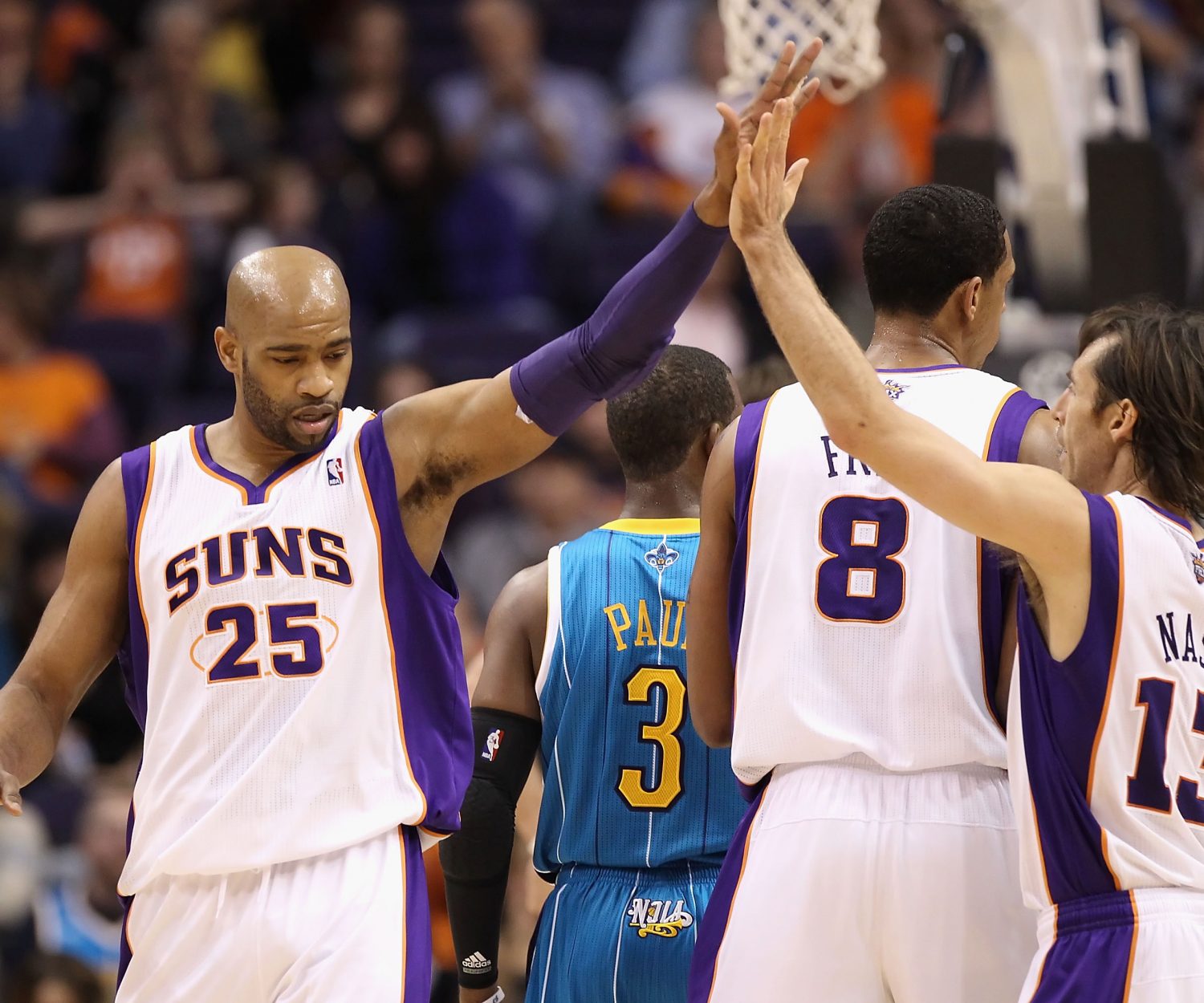 PHOENIX, AZ - JANUARY 30:  Vince Carter #25 of the Phoenix Suns high fives teammate Steve Nash #13 after scoring against the New Orleans Hornets during the NBA game at US Airways Center on January 30, 2011 in Phoenix, Arizona.  The Suns defeated the Hornets 104-102. NOTE TO USER: User expressly acknowledges and agrees that, by downloading and or using this photograph, User is consenting to the terms and conditions of the Getty Images License Agreement.  (Photo by Christian Petersen/Getty Images)